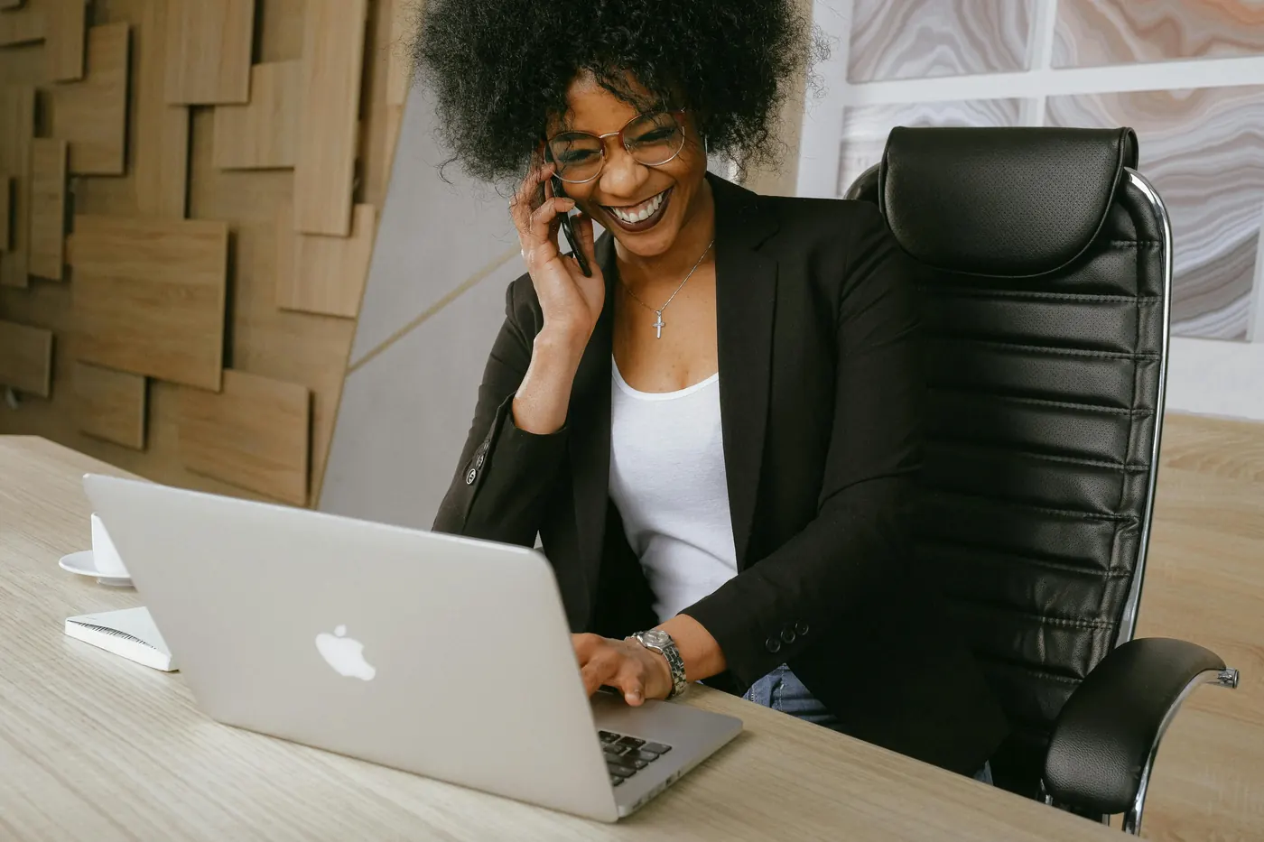 Woman on a phone call working at a laptop